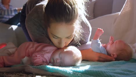 Mother-kissing-her-baby-boy-in-living-room-4k