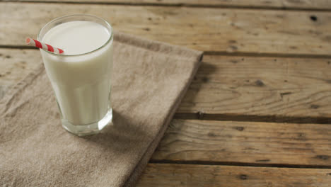 video of glass of fresh milk on wooden background