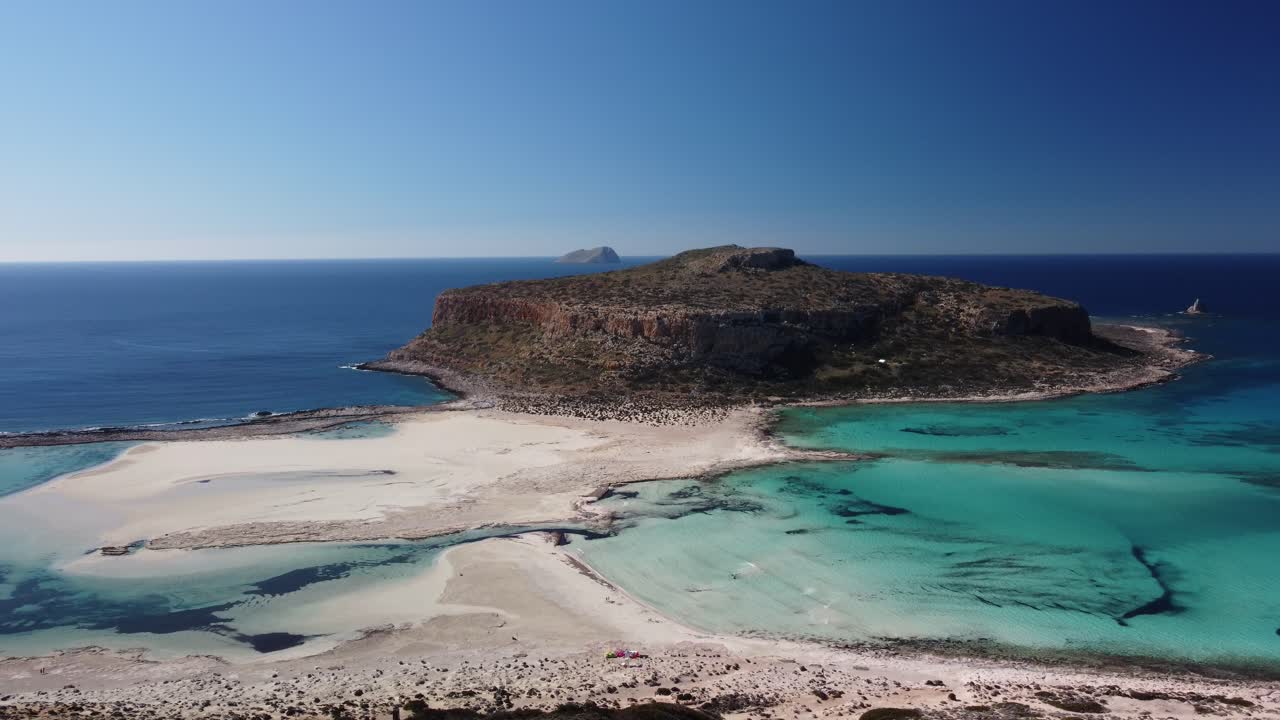 Woman on the coastline watches sea and beach. Vacation and relaxation concept
