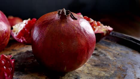 whole pomegranate fruit rotating on a table