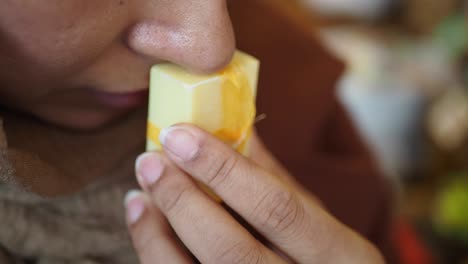 woman smelling a bar of soap