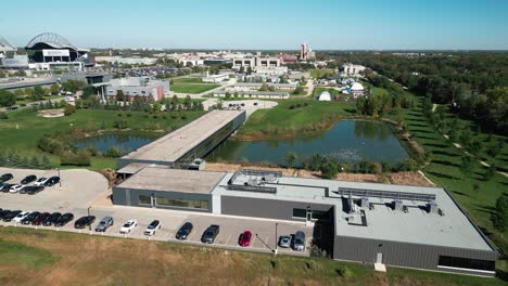 drone captures modern university of manitoba building over water in fall