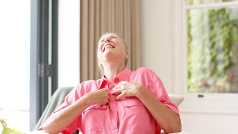 A-senior-joyful-Caucasian-woman-is-laughing-indoors-on-a-video-call