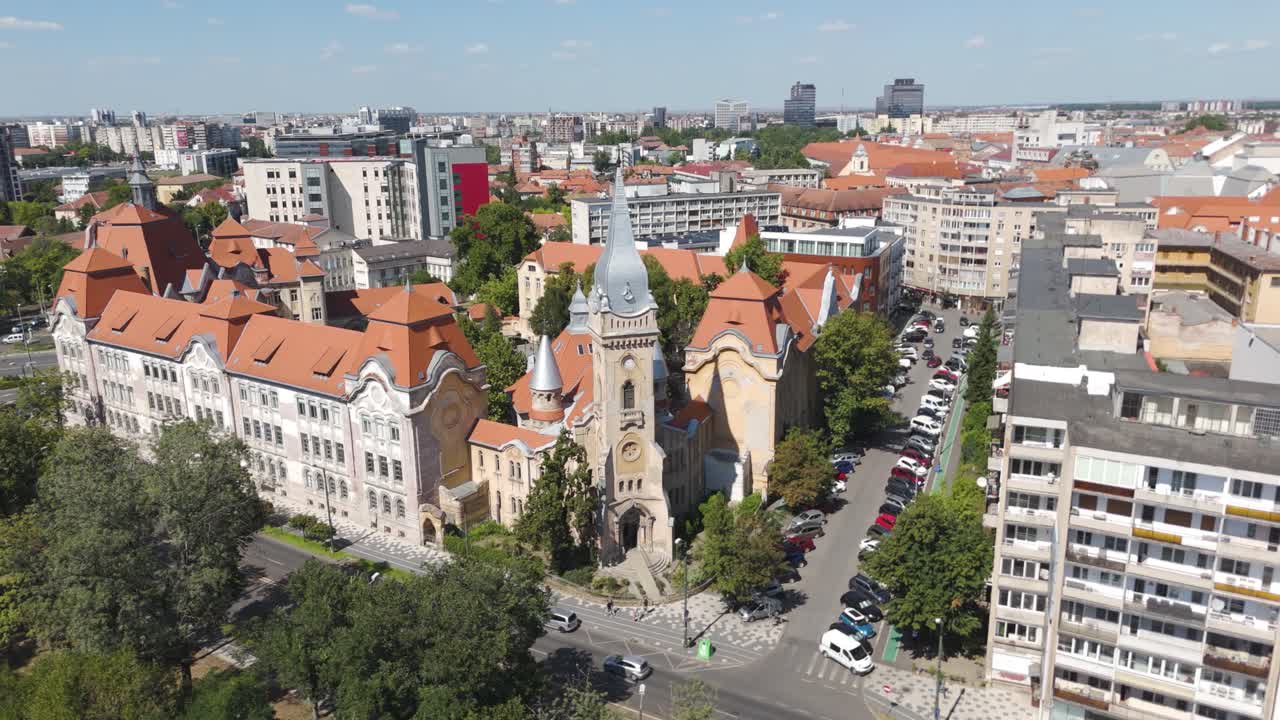 Aerial drone orbiting the Piarist Church in Timisoara, Romania, showcasing its architecture and the surrounding cityscape