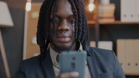 man using mobile phone for online payment in office