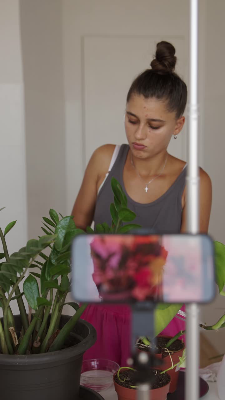 Woman filming plants indoors
