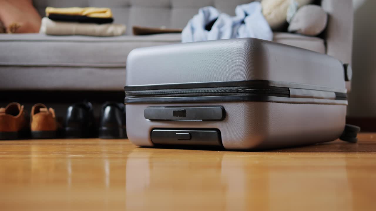 Tourism and travelling concept. Handsome business man going on holiday, packing his suitcase, checking luggage, sitting on bed and looking at packed things
