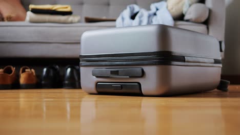 tourism and travelling concept. handsome business man going on holiday, packing his suitcase, checking luggage, sitting on bed and looking at packed things