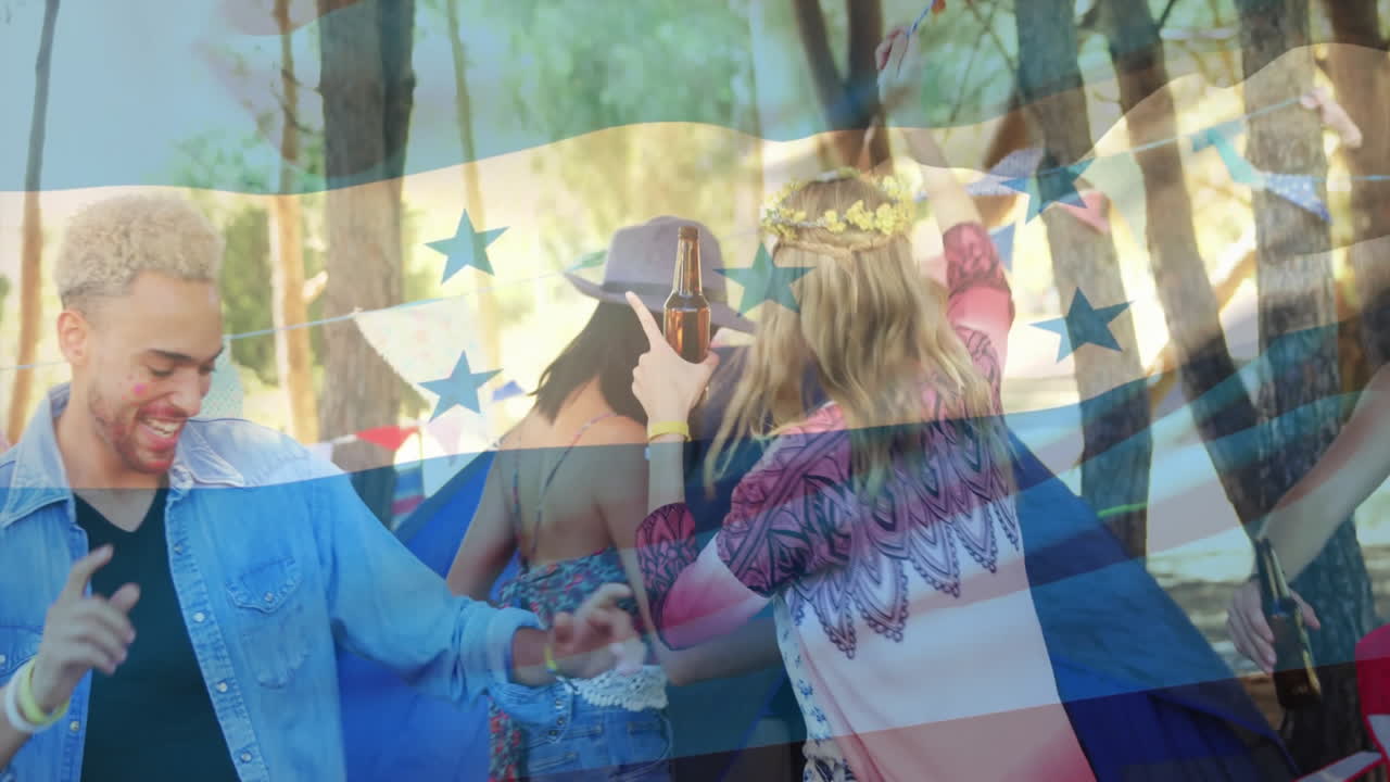 Dancing outdoors, people celebrating with Honduras flag animation overlaying scene