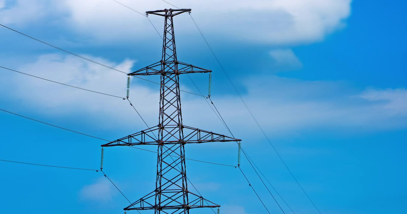 Time Lapse of Electricity Pylon Against Blue Sky with Moving Clouds