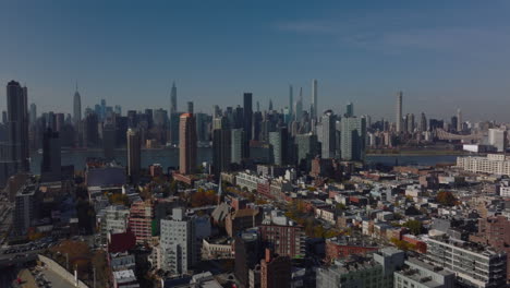 Rising-shot-of-residential-Queens-borough.-Revealing-tall-downtown-office-towers-on-Manhattan.-New-York-City,-USA