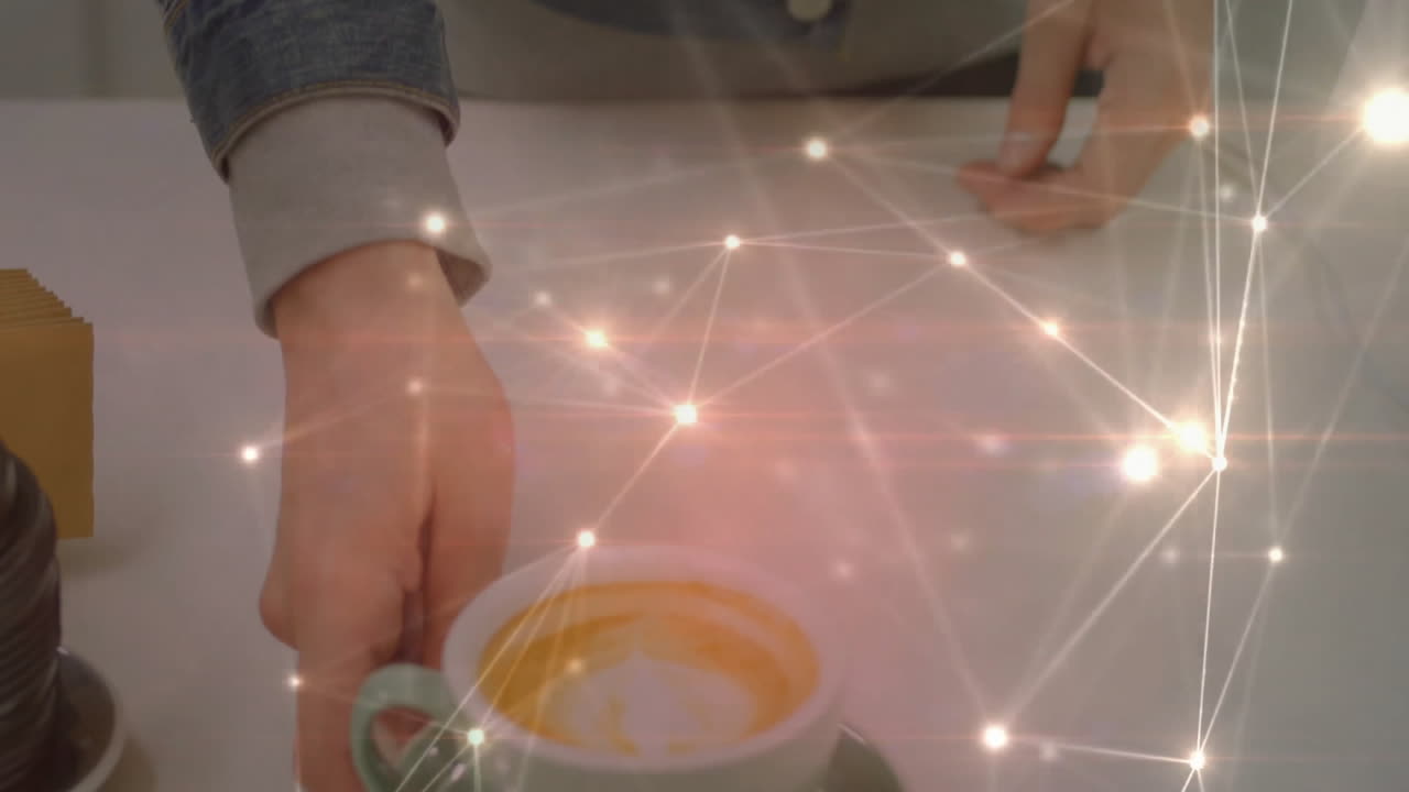Hands resting beside coffee cup, capsules on table showing digital network overlay for technology
