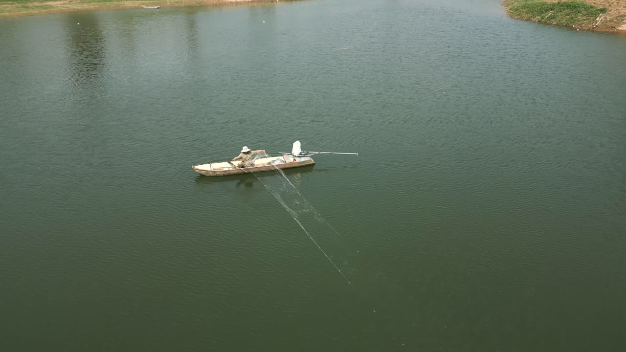 Fisherman Fishing in a Boat on a Calm Water