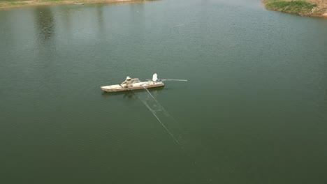 fisherman fishing in a boat on a calm water