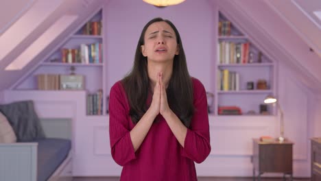 scared indian woman praying to god