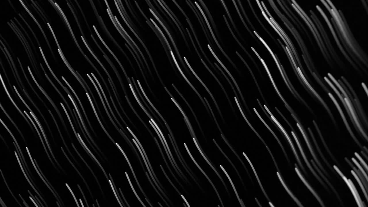 Animation of glowing lights trails against black background