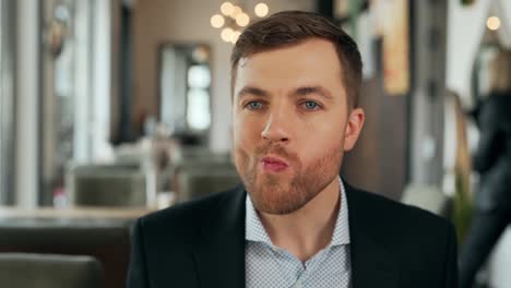 close-up portrait of a young man puts a salad with shrimp and chews