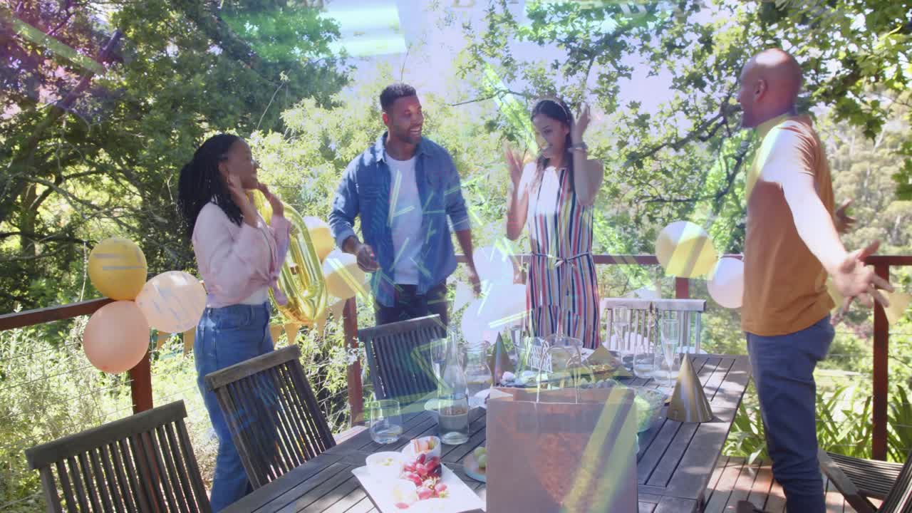 Woman presenting cake on deck, group applauding, honoree hiding face while confetti showering party