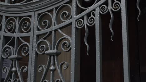 old wrought gate on church entrance door panning shot