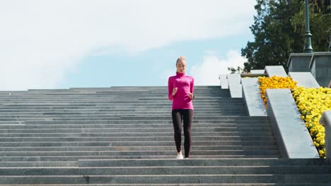 woman running up stairs in park