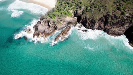 sea waves crashing on the rugged coast of noosa national park in qld, australia