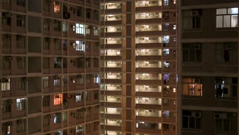 a nighttime view of a crowded high-rise public housing apartment building in hong kong