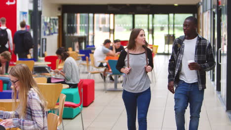 communal area of busy college campus with students