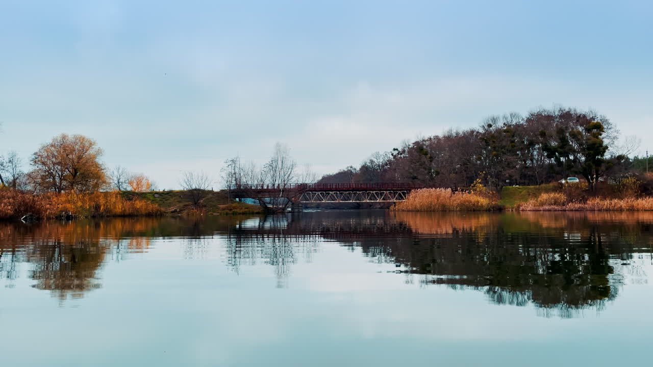 Autumn Bridge over a Calm Lake