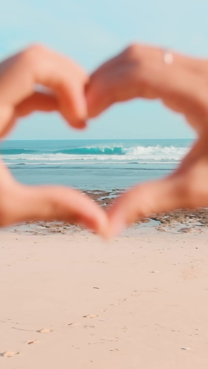 Waves crashing on a serene beach with golden sand and rocky shores