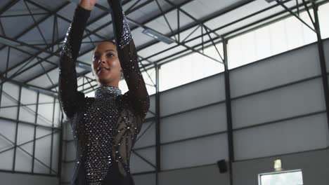 female gymnast performing at sports hall