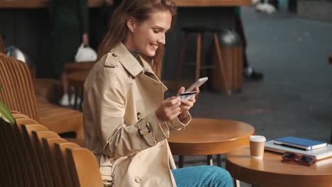 caucasian female student online shopping on smartphone outdoors.