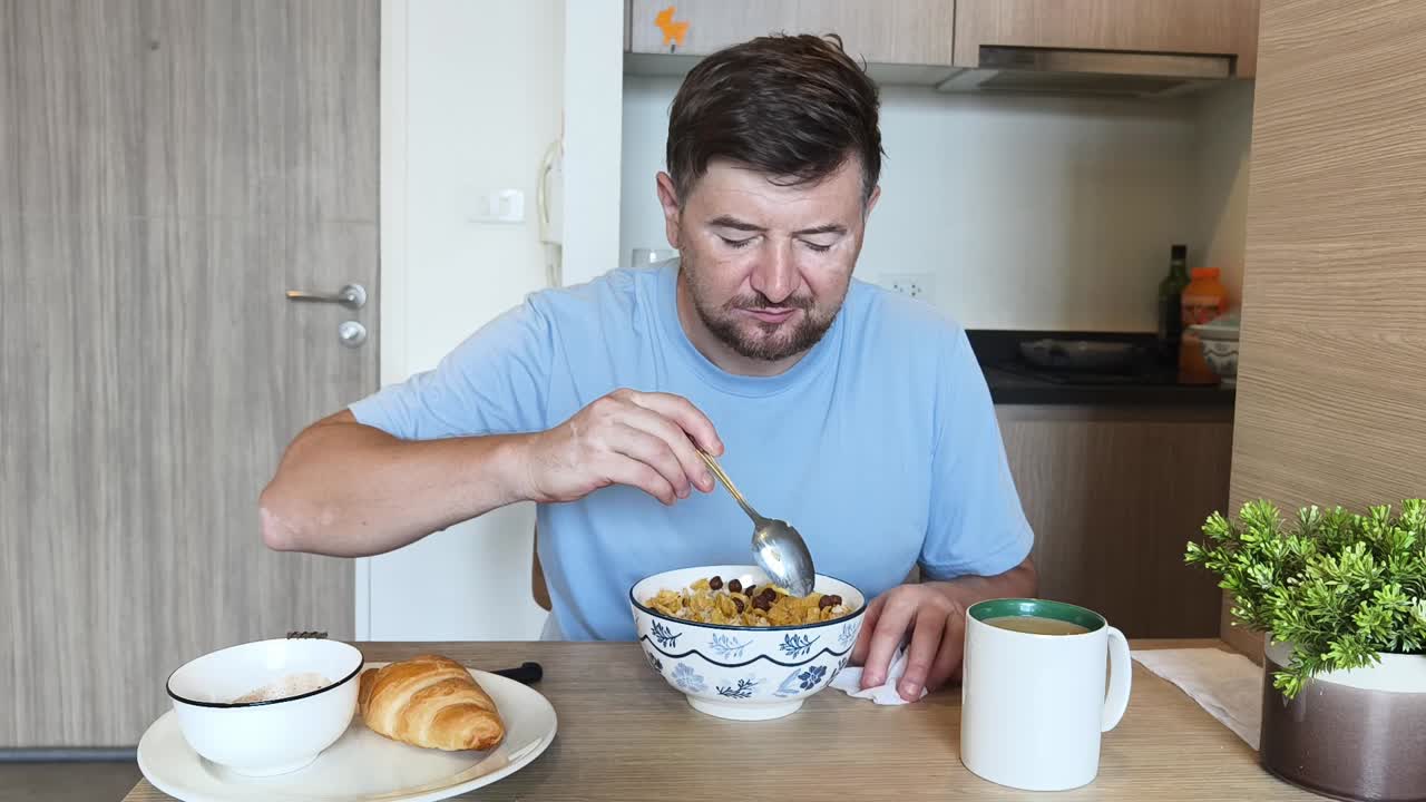 Man eating breakfast at a table