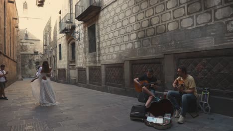 street musicians and couple in barcelona alley