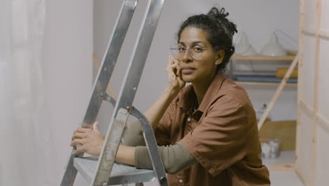 woman with glasses looking at camera