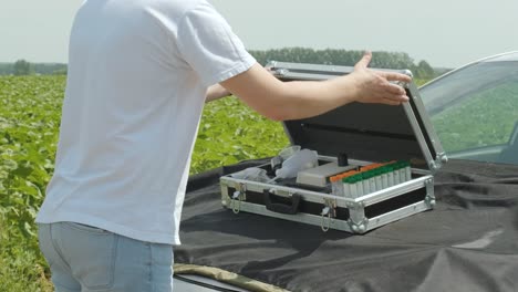 laboratory assistant conducting research on plants in the field