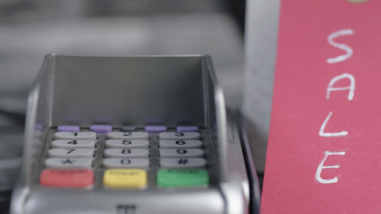 Sale sign and pdq payment machine panning shot close up shot