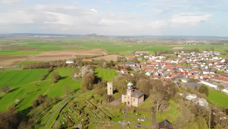 Aerial-of-a-medieval-Tower-and-a-Church-on-a-Hill,-Wettenberg,-Germany