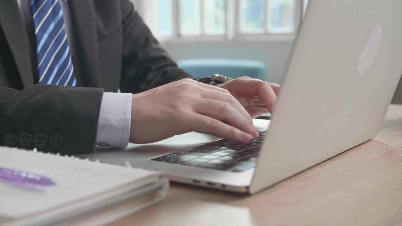 Close Up Of Asian Businessman Wearing Business Suit Typing On Computer While Working At Home.