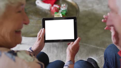 Sonriente-Pareja-Caucásica-Mayor-Haciendo-Videollamada-Navideña-Con-Tableta,-Copiando-Espacio-En-La-Pantalla