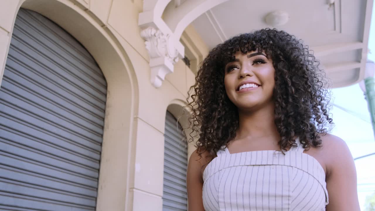 A woman with curly hair in an urban setting