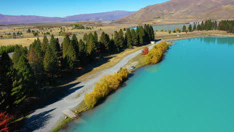 aerial view along the shore of the turquoise lake pukaki in the mountain wilderness of new zealand