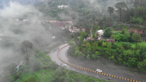 aerial view of curve of four lane e75 expressway on misty foggy day