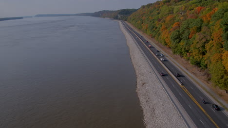 drone pushes forward alongside the great river road and bluffs in the fall