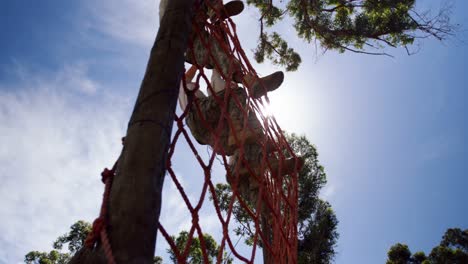 military troops climbing a net during obstacle course 4k