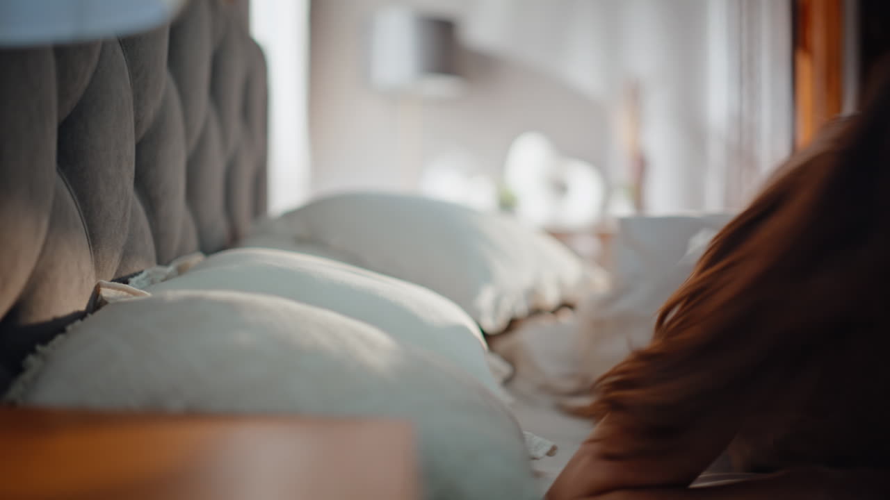 Overslept woman looking cellphone jumping from bed feeling stress closeup