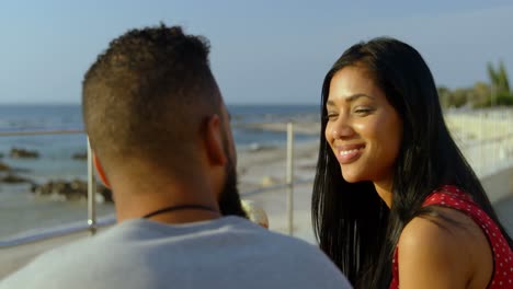 Young-mixed-race-couple-interacting-with-each-while-having-ice-cream-cones-4k