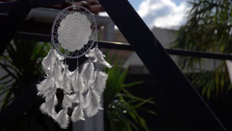 white dreamcatcher in the breeze