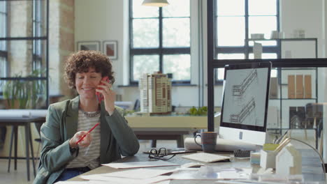 professional woman architect talking on smartphone in a modern office