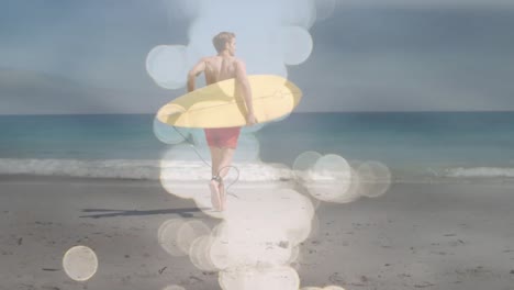 Animation-of-water-reflection-over-back-view-of-caucasian-male-surfer-running-into-sea