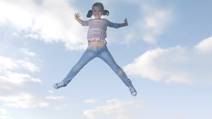 Animation of clouds over smiling biracial girl jumping